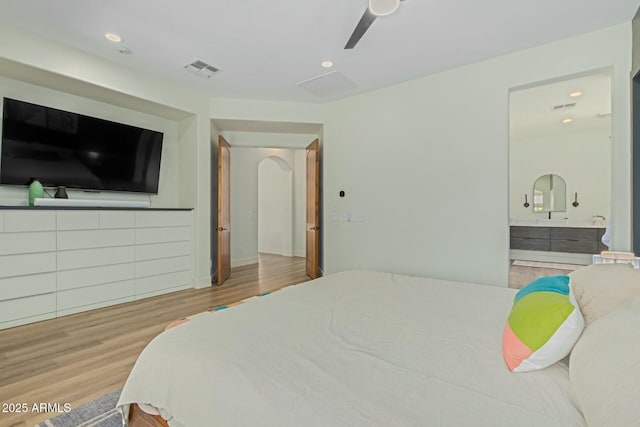 bedroom featuring wood finished floors, recessed lighting, ensuite bathroom, and ceiling fan