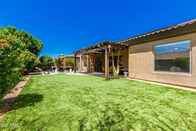 view of grassy yard with a pergola and a patio area