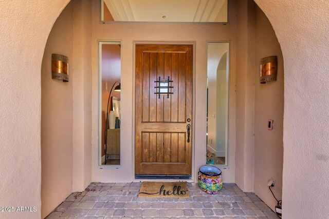 entrance to property with stucco siding