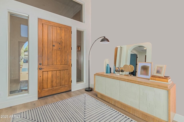 entrance foyer with wood finished floors and baseboards