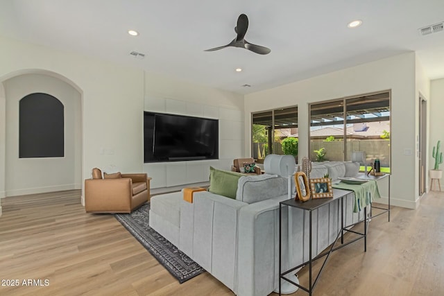 living room featuring light wood-type flooring, recessed lighting, a ceiling fan, and baseboards