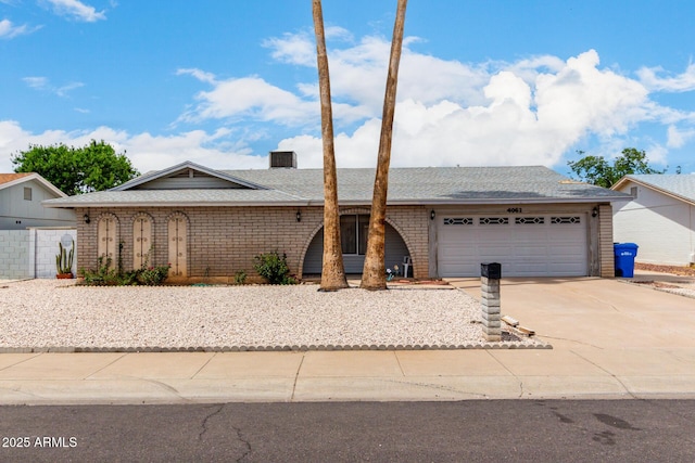 4062 W Mescal St, Phoenix, AZ 85029 - single story home featuring concrete driveway, an attached garage, a shingled roof, and brick siding