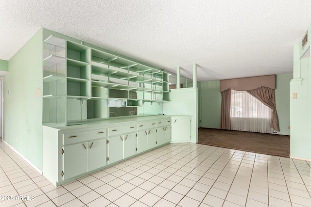 4062 W Mescal St, Phoenix, AZ 85029 - kitchen featuring a textured ceiling, light tile patterned floors, open shelves, and light countertops