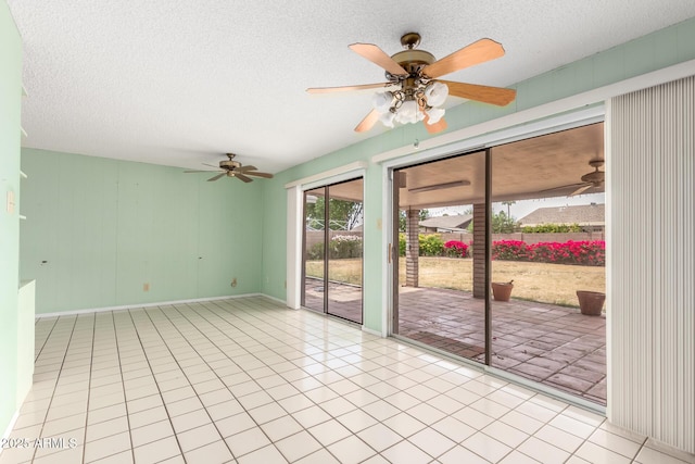 4062 W Mescal St, Phoenix, AZ 85029 - tiled empty room with a textured ceiling, a ceiling fan, and baseboards