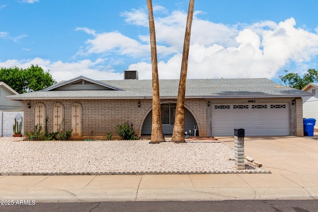 4062 W Mescal St, Phoenix, AZ 85029 - ranch-style home featuring an attached garage, driveway, a shingled roof, and brick siding