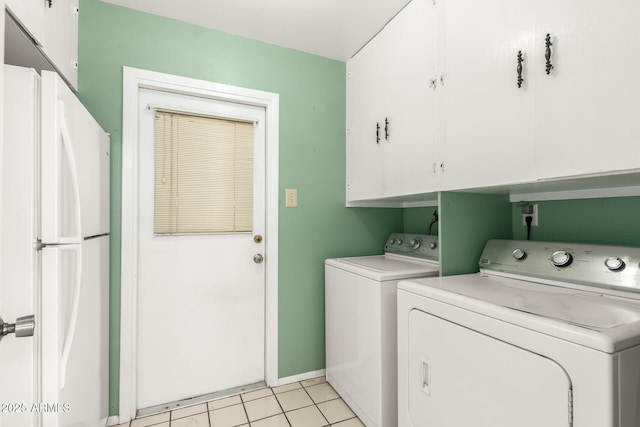 4062 W Mescal St, Phoenix, AZ 85029 - laundry room with washing machine and dryer, cabinet space, light tile patterned flooring, and baseboards