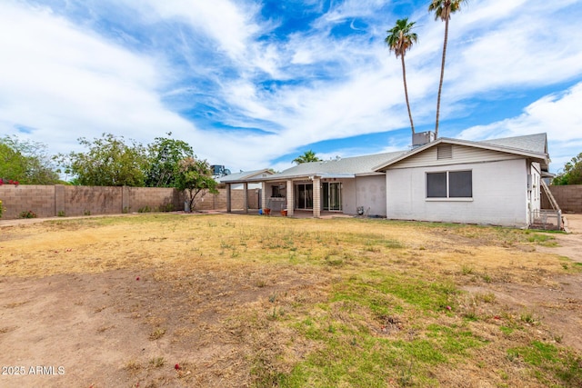 4062 W Mescal St, Phoenix, AZ 85029 - rear view of house with a fenced backyard and concrete block siding