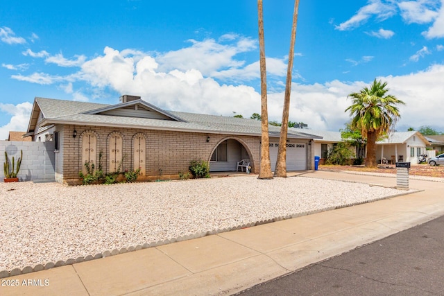 4062 W Mescal St, Phoenix, AZ 85029 - ranch-style house featuring concrete driveway, an attached garage, brick siding, and a shingled roof