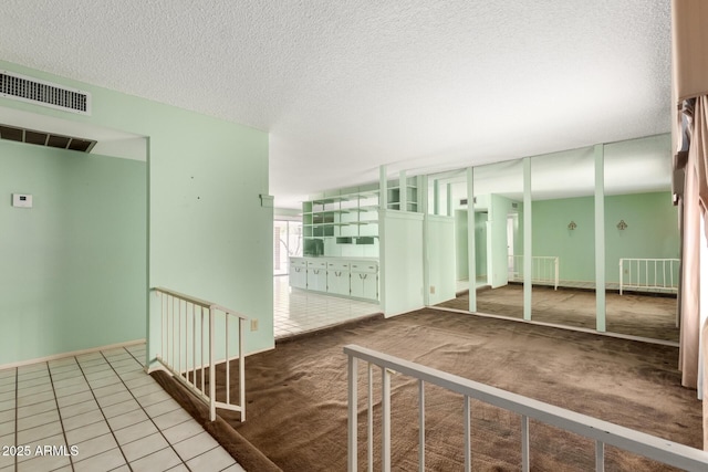 4062 W Mescal St, Phoenix, AZ 85029 - hallway featuring a textured ceiling, carpet floors, and tile patterned floors