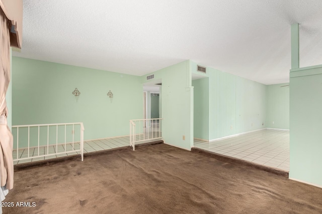 4062 W Mescal St, Phoenix, AZ 85029 - tiled empty room featuring carpet floors, a textured ceiling, and baseboards