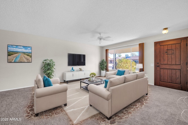 carpeted living room featuring ceiling fan and a textured ceiling