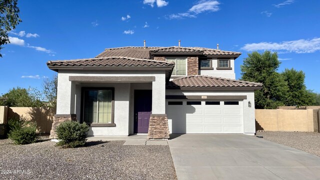 mediterranean / spanish-style home with a garage