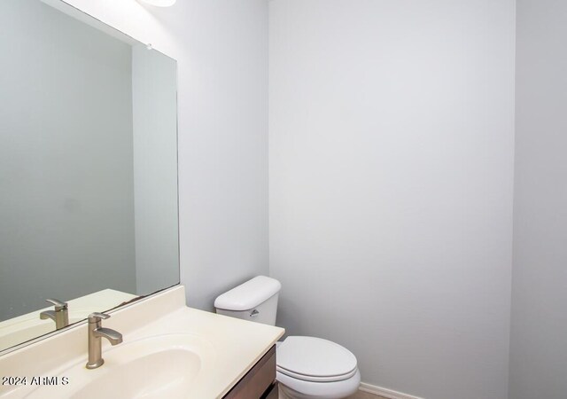 bathroom featuring toilet and vanity