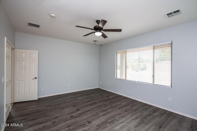 empty room featuring ceiling fan and dark hardwood / wood-style flooring