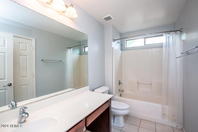 full bathroom with tile patterned flooring, shower / bath combination with curtain, toilet, and vanity