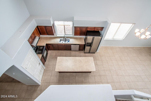 kitchen featuring sink, stainless steel appliances, and light tile patterned floors