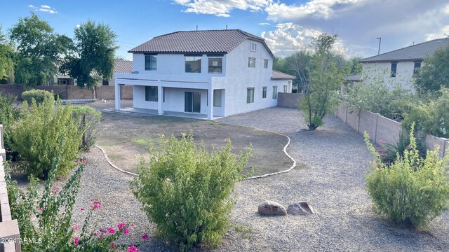 rear view of property featuring a patio area