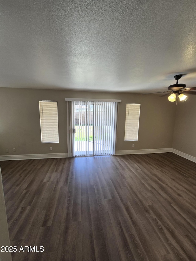 spare room featuring ceiling fan, a textured ceiling, and dark hardwood / wood-style flooring