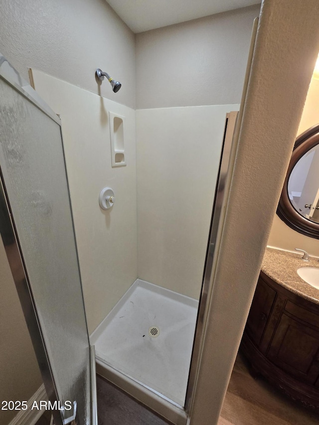 bathroom featuring vanity, hardwood / wood-style floors, and a shower