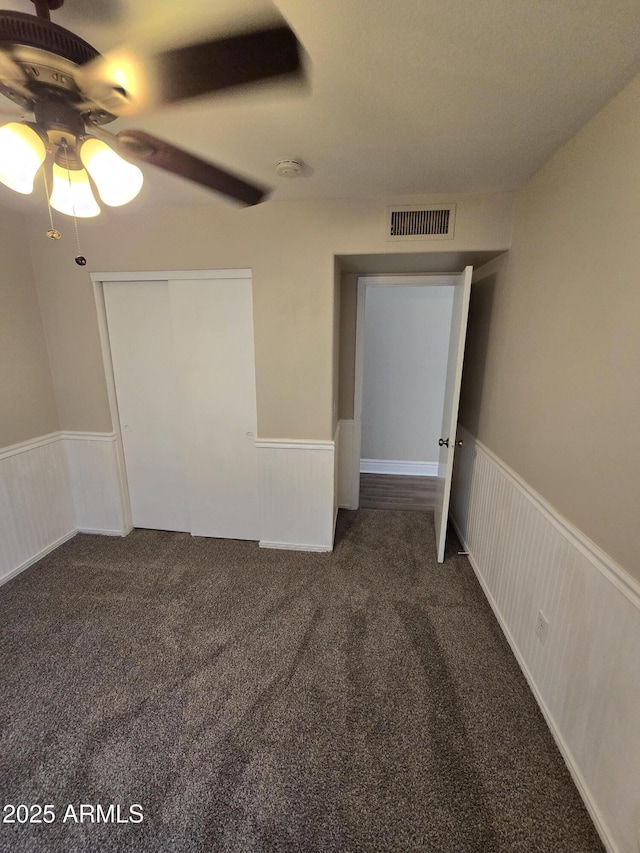 carpeted empty room with ceiling fan