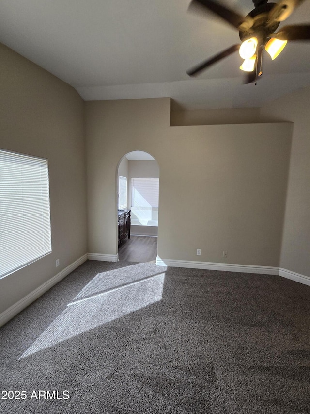 carpeted empty room with ceiling fan and lofted ceiling