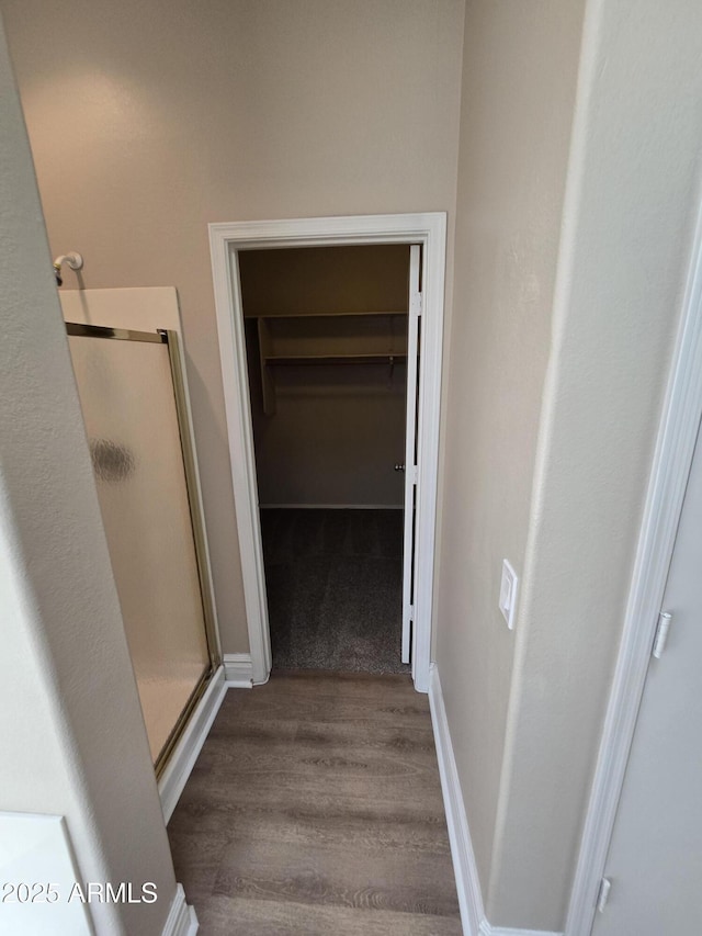 bathroom with walk in shower and wood-type flooring