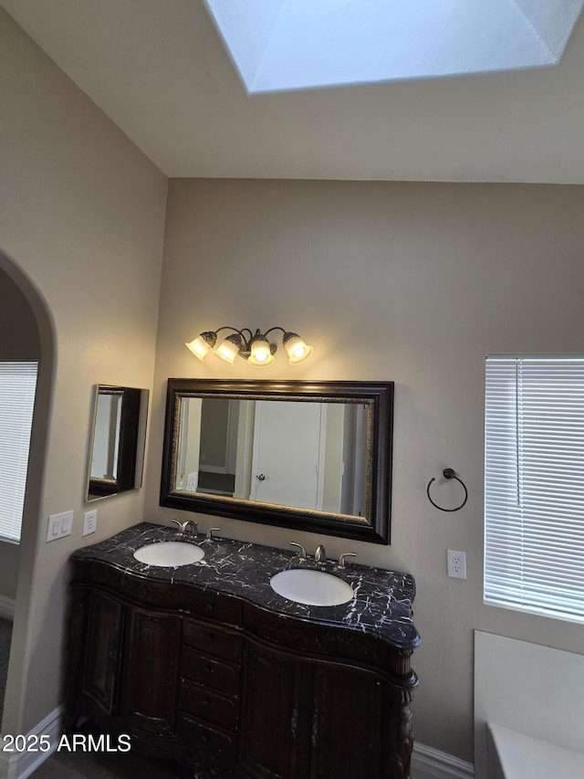 bathroom featuring vanity and a washtub