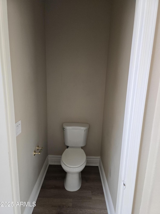 bathroom featuring hardwood / wood-style flooring and toilet