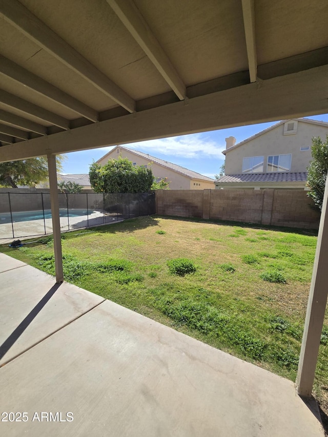 view of yard featuring a fenced in pool and a patio