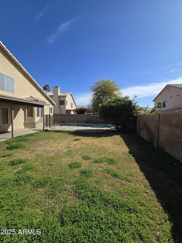 view of yard with a fenced in pool and a patio area