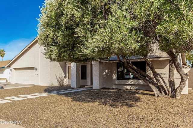 view of front of house with an attached garage and stucco siding