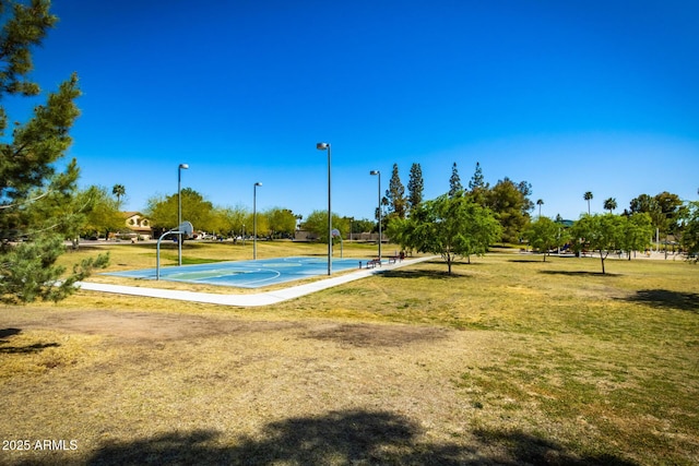 view of sport court featuring community basketball court and a lawn