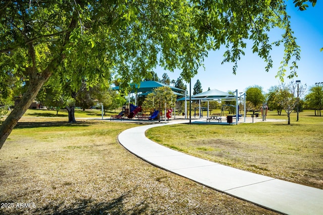 view of community featuring playground community and a yard