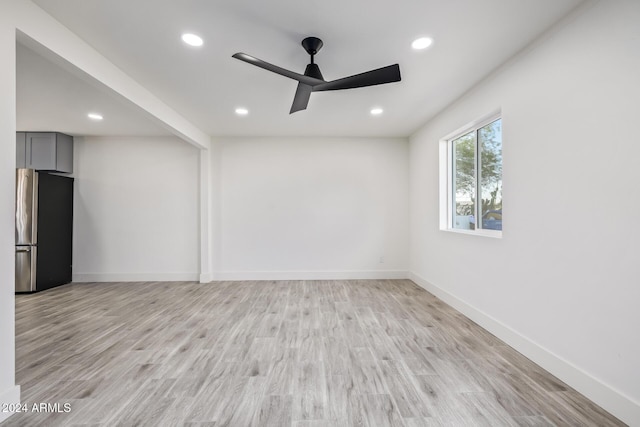 unfurnished room featuring light hardwood / wood-style floors and ceiling fan