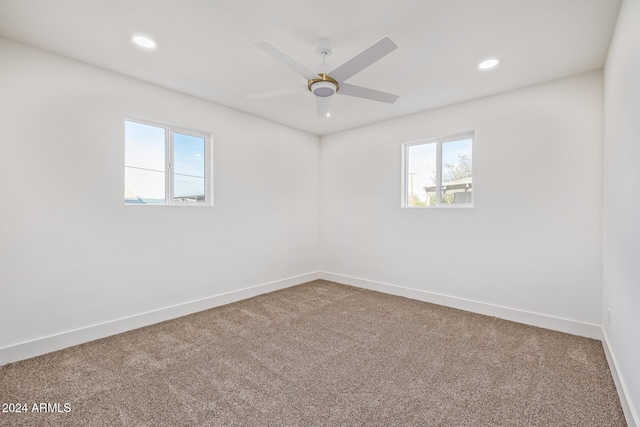 spare room featuring carpet floors and ceiling fan