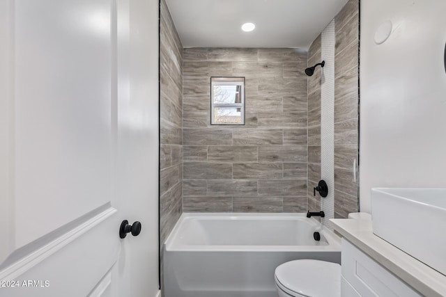 bathroom featuring tiled shower / bath and toilet