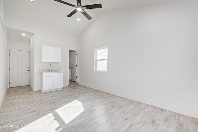 spare room featuring high vaulted ceiling, ceiling fan, and sink