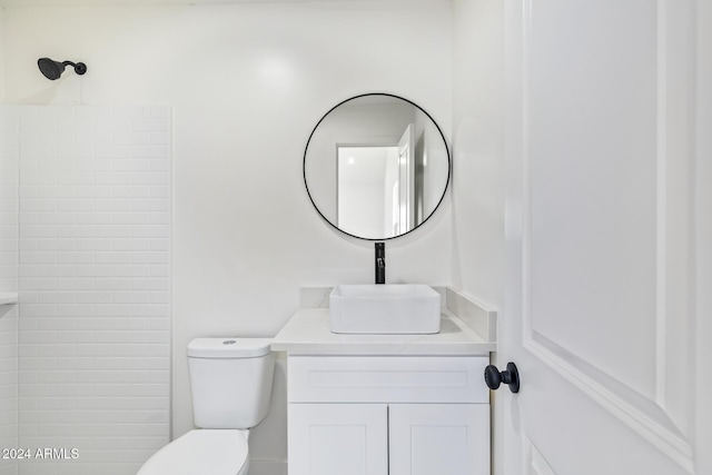 bathroom featuring vanity, toilet, and walk in shower