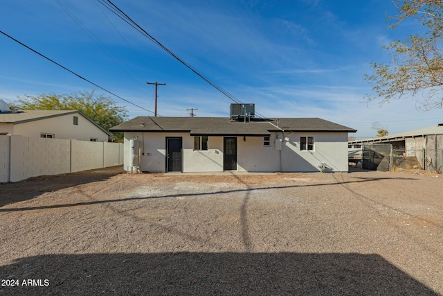 rear view of house featuring cooling unit