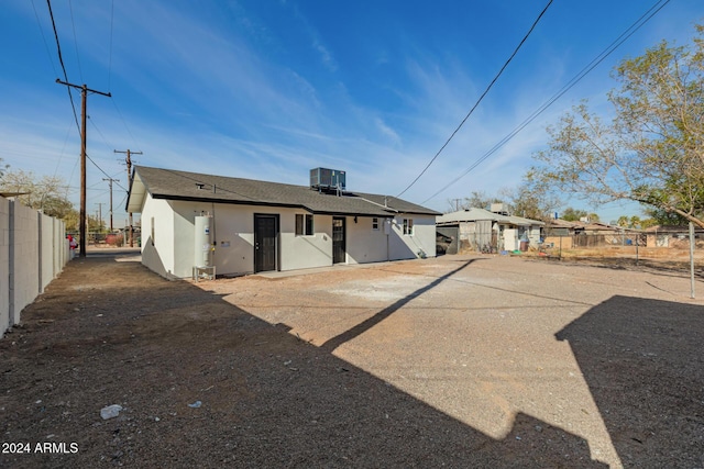 back of house featuring central AC unit