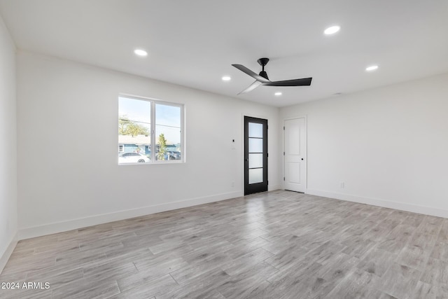 empty room with ceiling fan and light wood-type flooring