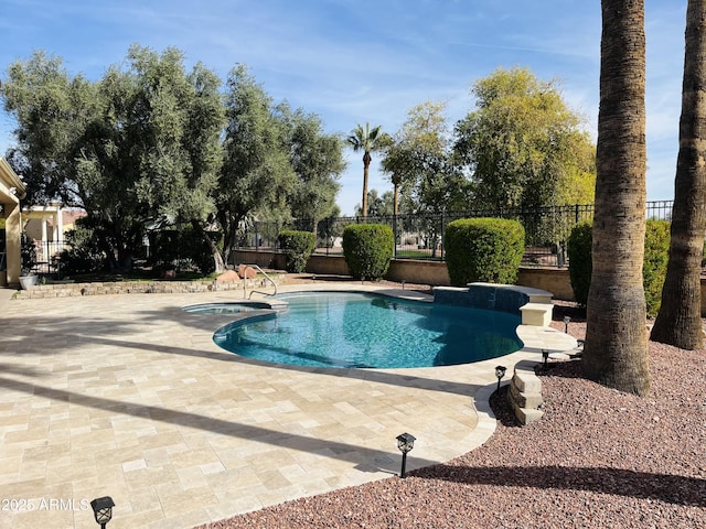 view of swimming pool with a patio area, fence, and a fenced in pool