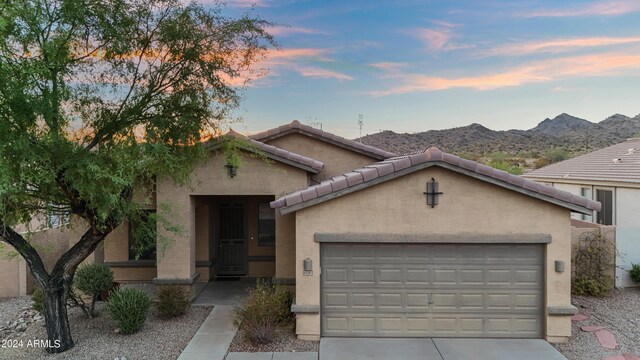 view of front facade featuring a mountain view and a garage