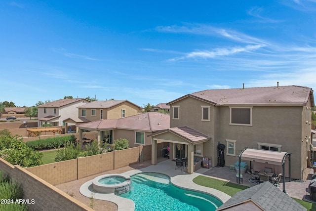 view of swimming pool with a patio area and an in ground hot tub