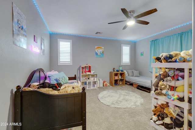 bedroom with carpet flooring, multiple windows, and ceiling fan