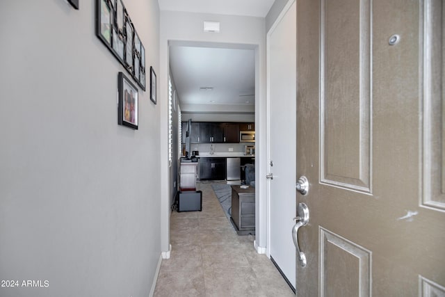 hall featuring light tile patterned flooring