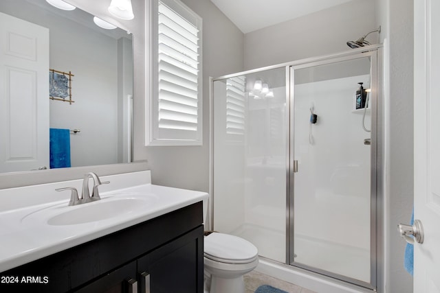 bathroom featuring toilet, an enclosed shower, and a healthy amount of sunlight