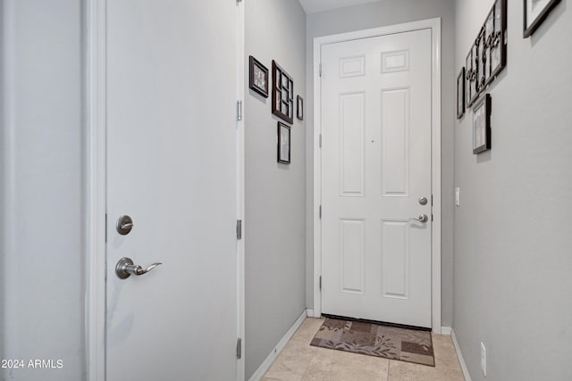 doorway with light tile patterned floors