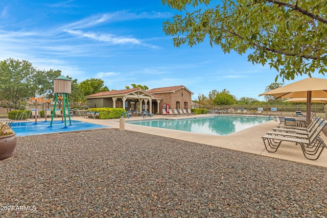 view of swimming pool with a patio and a playground