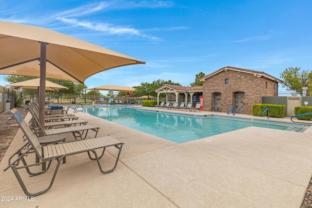 view of swimming pool featuring a patio area and a fireplace